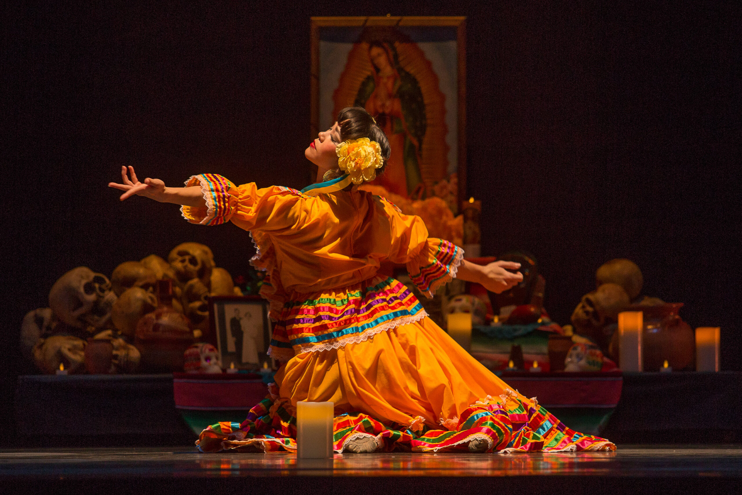 Luna Mexicana_Oakland Ballet_Luna at the Ofrenda Dancer in folklorico dress reaching her hand to the left