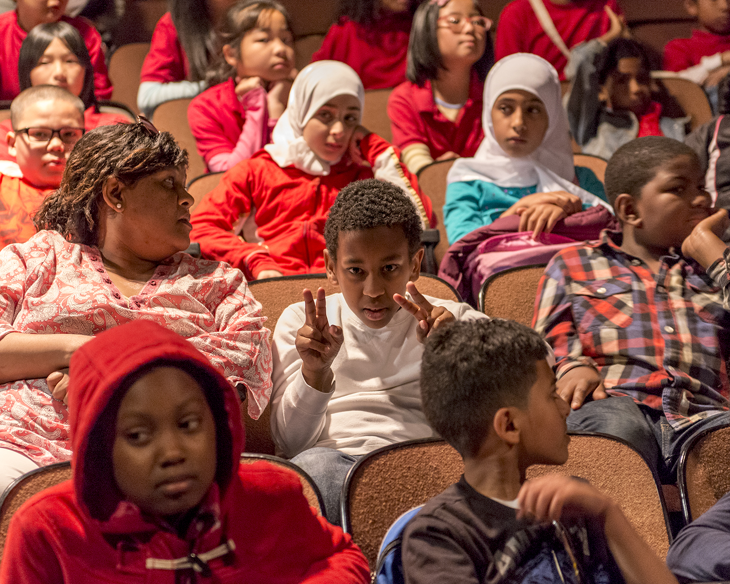 Students in theater ready to watch the show.