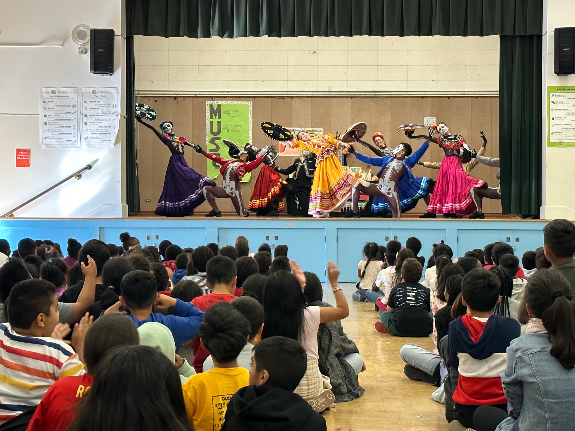 Lockwood 3 OBC dancers performing for students on a school stage.