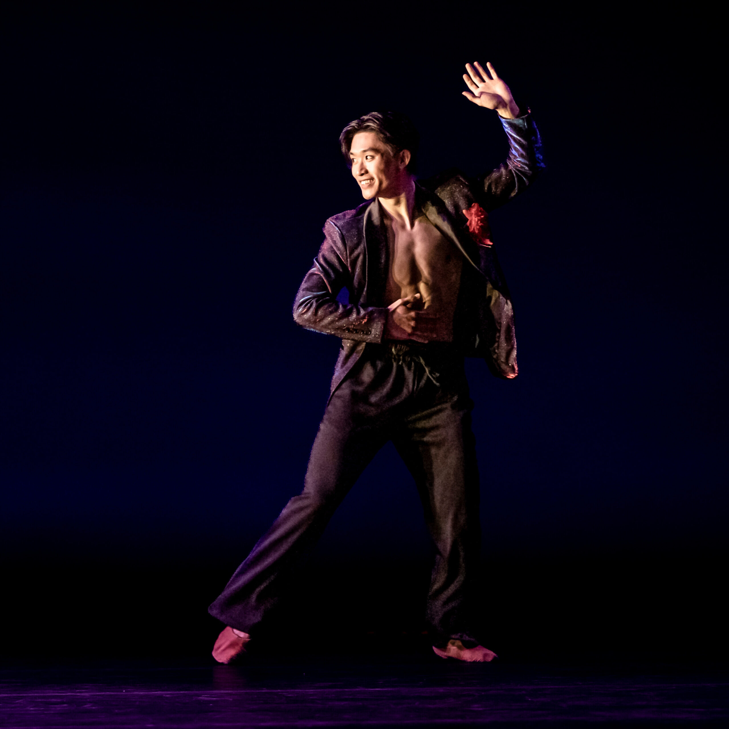 Lawrence Chen with left hand in air looking to the left