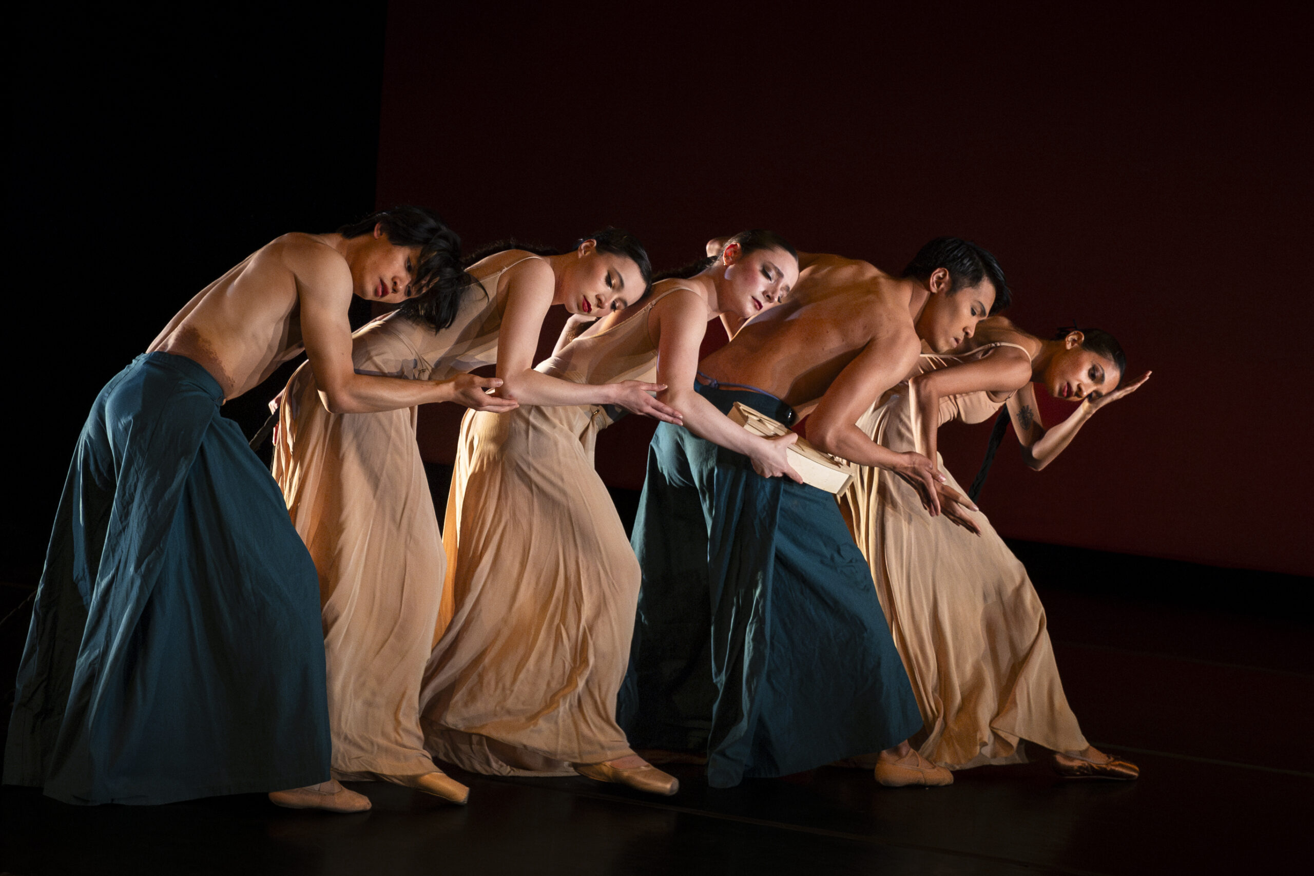 _J1A0722-Enhanced-NR Dancers in a line facing the right leaned over one another.