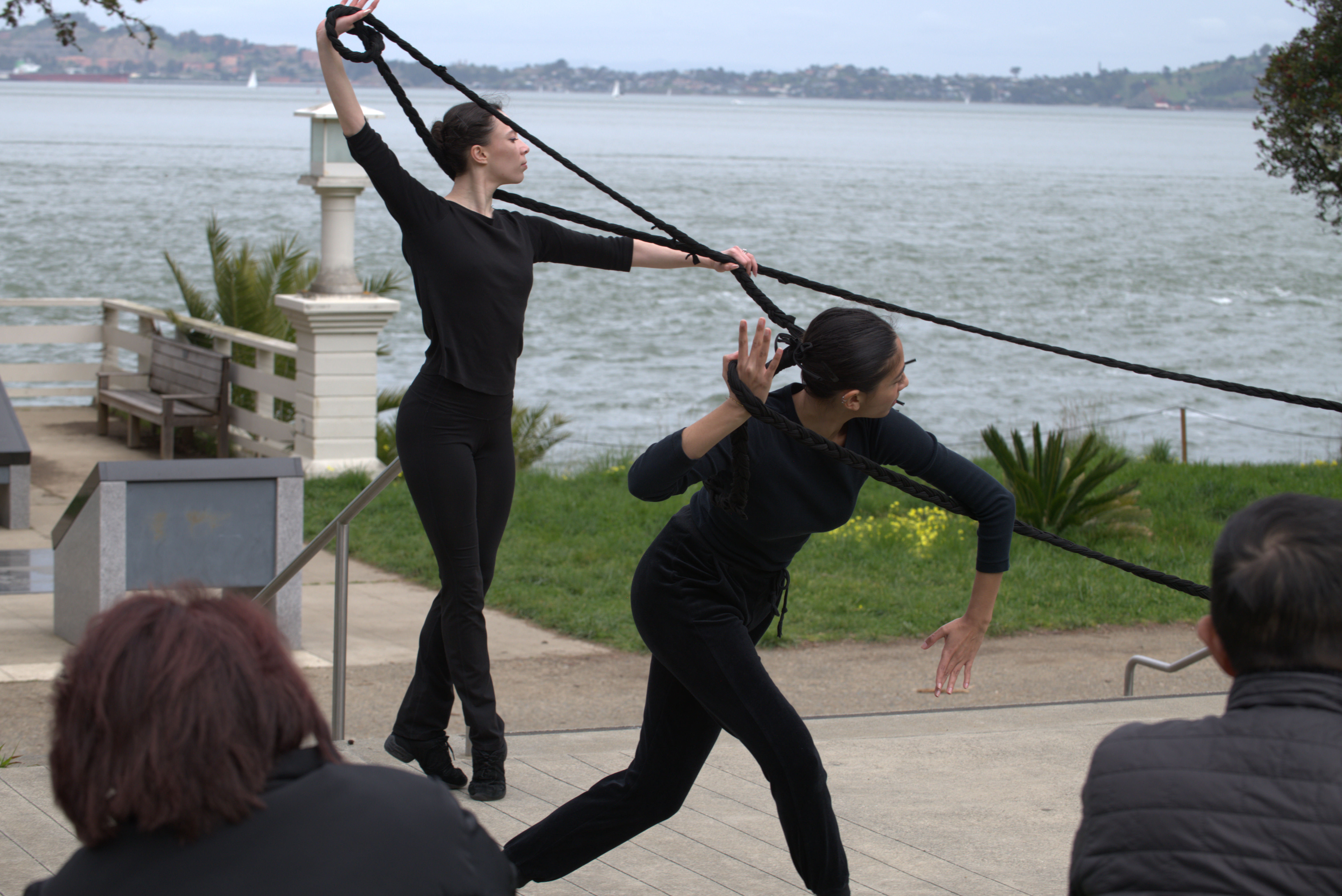 dance1 2 dancers looking to the right attached by a long braid on Angel Island